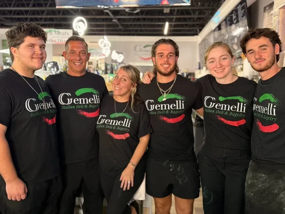 The Gemelli family and team behind the counter of the New Bern deli